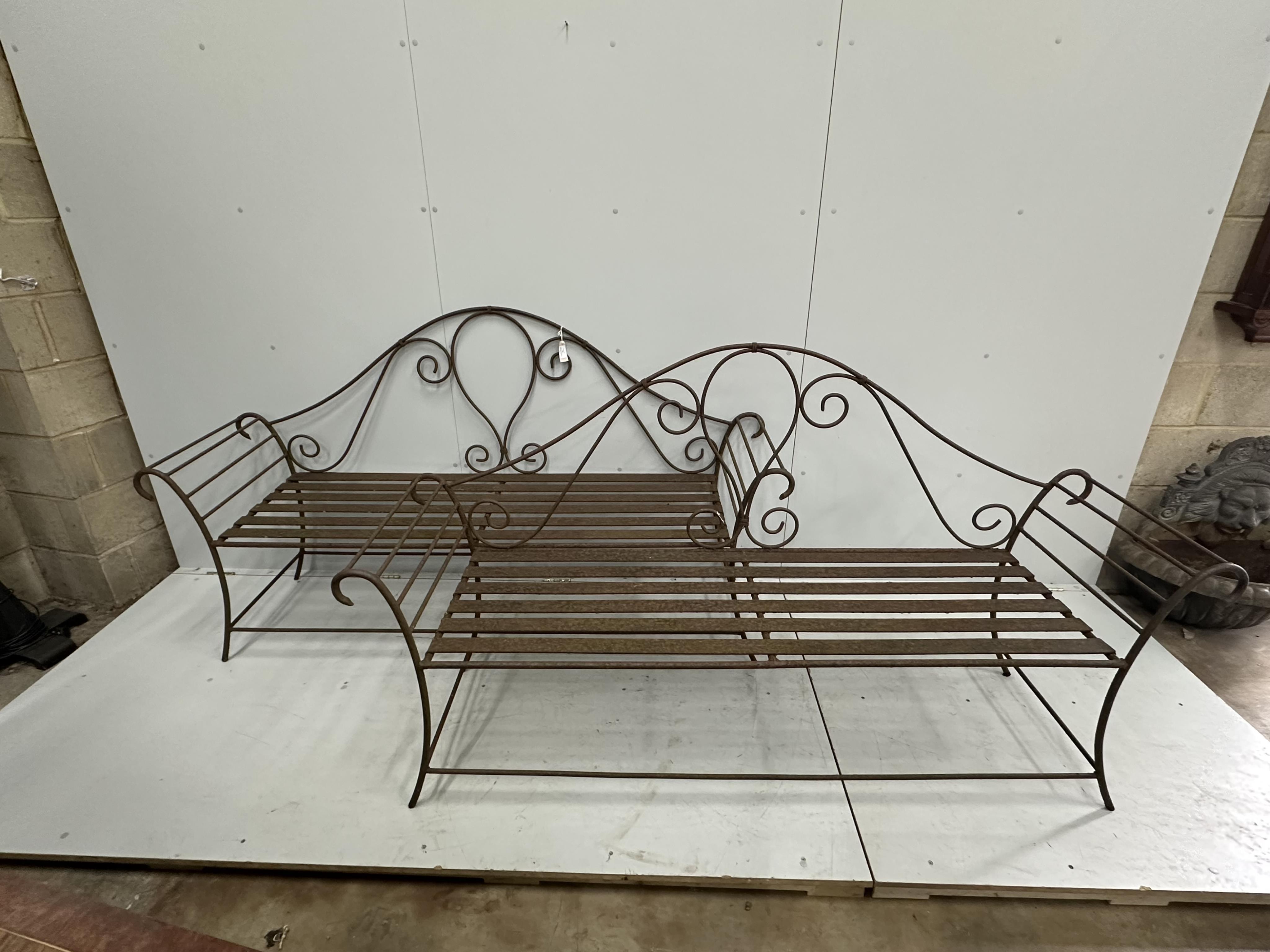 A pair of wrought iron garden benches, width 184cm, height 102cm. Condition - fair